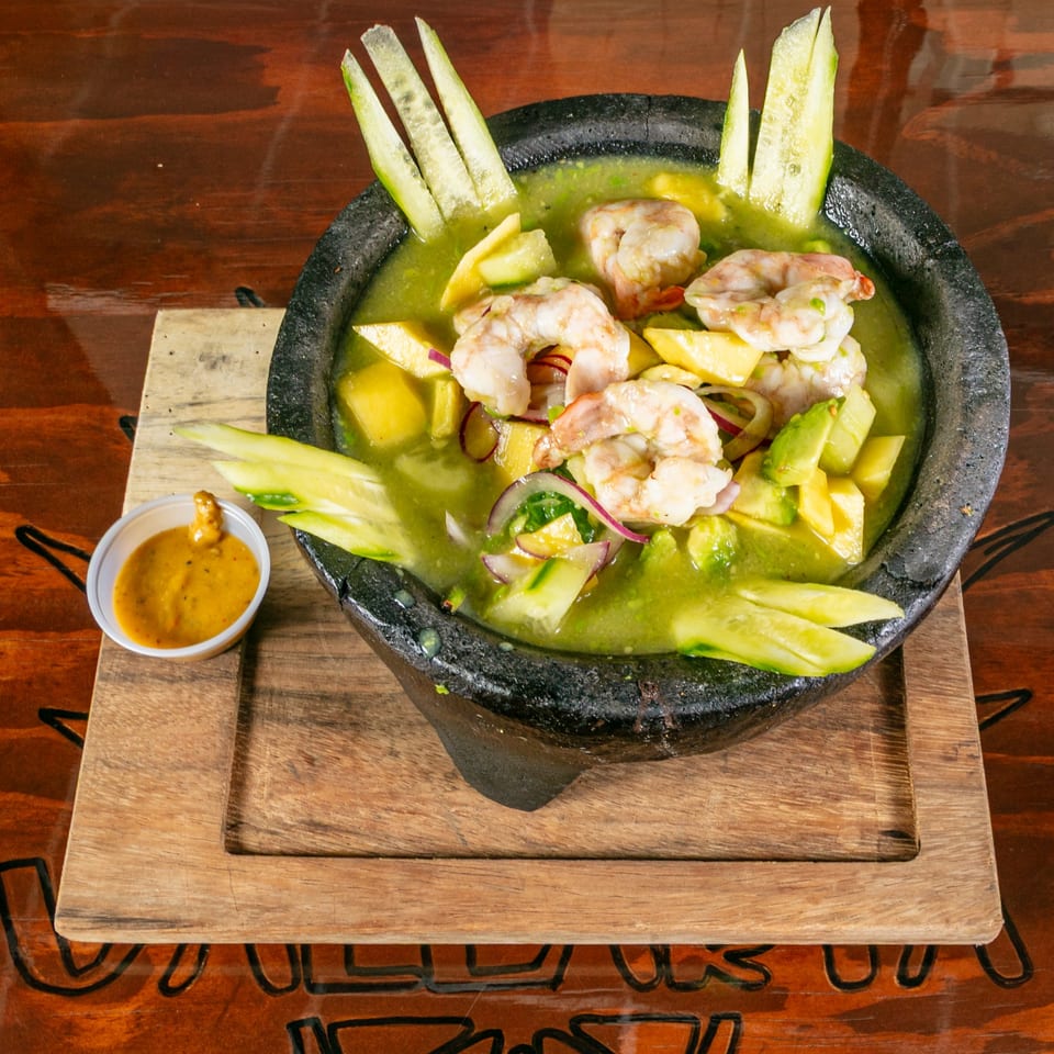 Vallarta Tequila Bar's shrimp ceviche in a molcajete with green sauce, avocado, and cucumber.